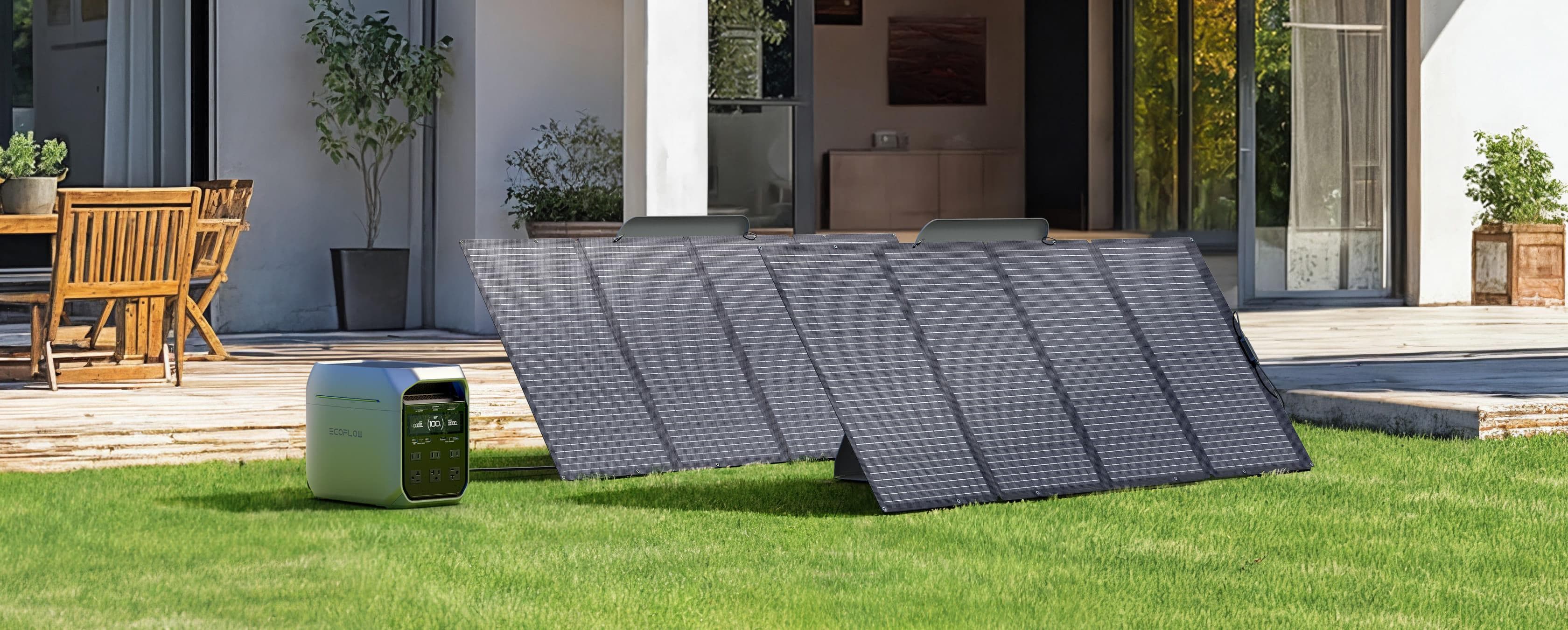 EcoFlow DELTA 3 Plus 1,800W 1,024Wh Plus Portable Solar Power Station Two EcoFlow DELTA 3 Plus 1,800W 1,024Wh Portable Solar Power Stations are placed on a grassy lawn near a modern house with patio and wooden furniture, efficiently capturing sunlight for energy with high-performance solar charging.