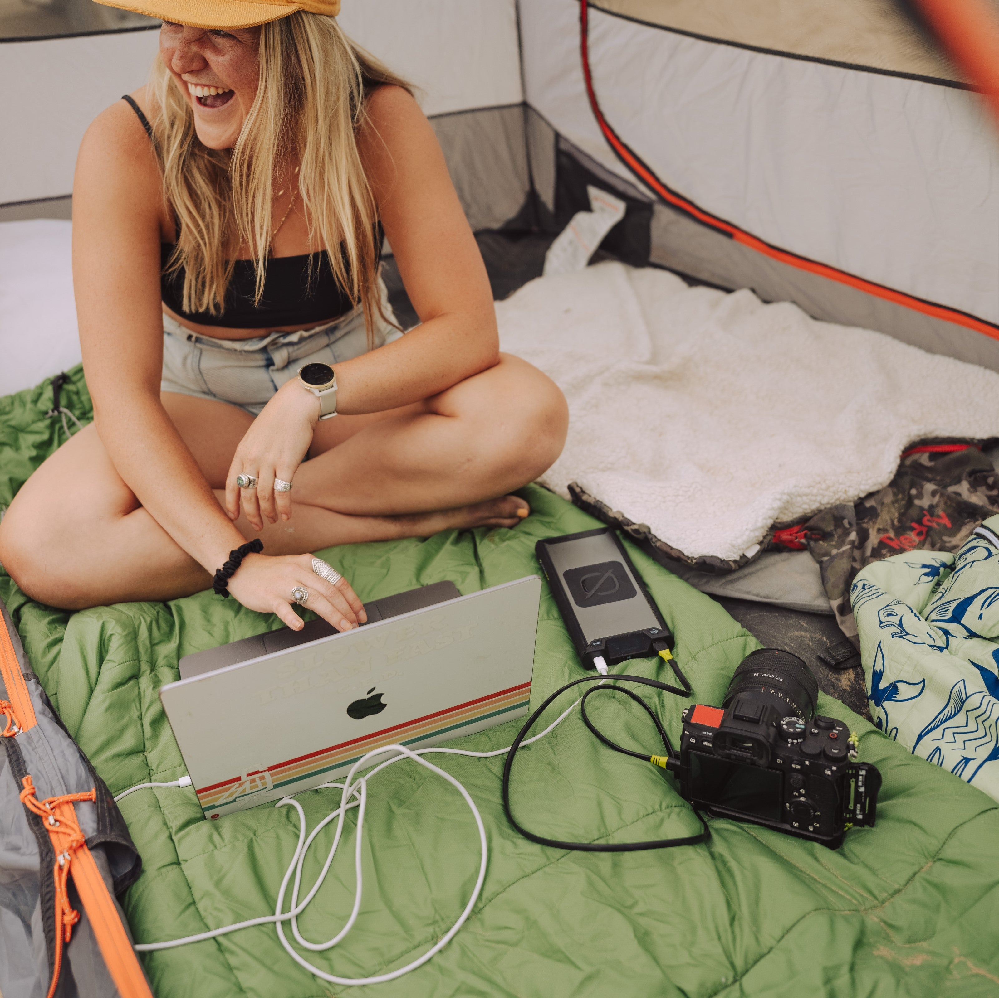 New Sherpa 100PD + 65W USB-C Charger Tech Kit New Sherpa 100PD Wireless Charging Power Bank charging an Apple MacBook and Camera at the same time