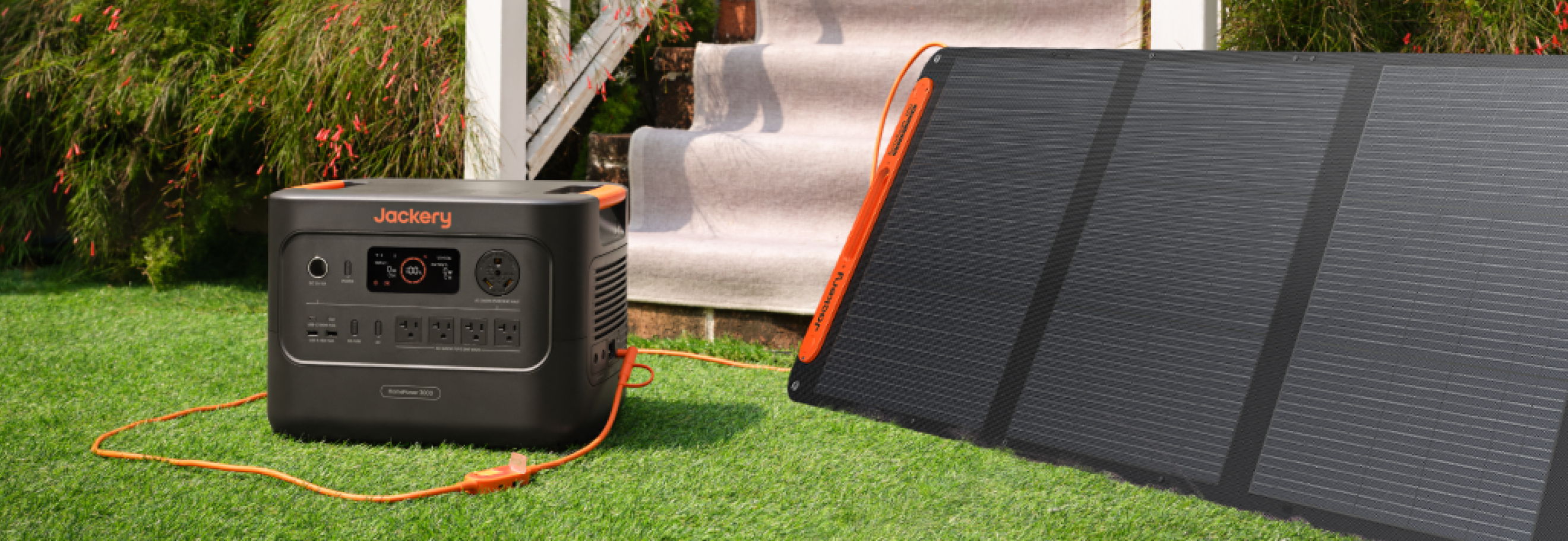 Jackery SolarSaga 200W Portable Solar Panel | 200W Folding Bifacial Panel | IP68 Waterproof Jackery SolarSaga 200W charging a power station in a backyard