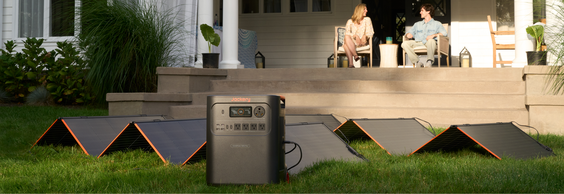Jackery SolarSaga 500 X array charging a power station on a lawn